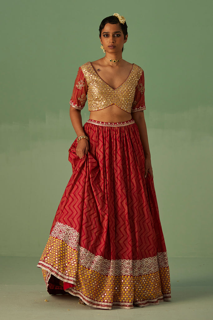 Red lehenga matched with gold embroidered blouse on Kalki